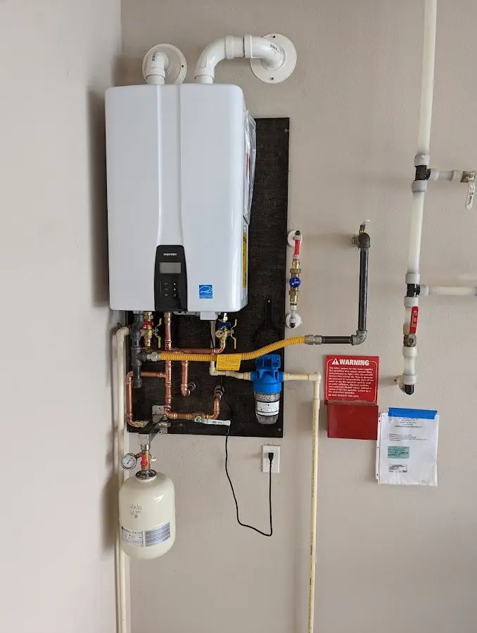 Professional plumber installing copper piping in a Beachwood home